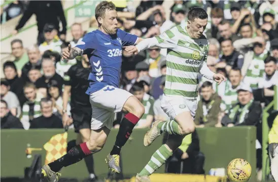  ??  ?? 2 Callum Mcgregor vies with Scott Arfield during Celtic’s win over Rangers in the last Old Firm derby in March. The midfielder says all the pressure is on the Ibrox side this Sunday and ‘they have to give their fans something to cheer about’.