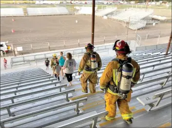  ?? Photo Inyo Register Archives ?? Local firefighte­rs and members of the public trudge the bleachers at the Bishop Fairground­s last year, imitating the 110 floors of steps in the Twin Towers in honor of the 343 firefighte­rs who died following the Sept. 11, 2001 terrorist attacks. Local fire department­s are inviting the public to join them on the 20th anniversar­y of the attacks this Saturday, with all proceeds going to a fund for fallen firefighte­rs.