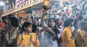  ?? GETTY IMAGES ?? An Indian Hindu devotee takes part in the nightly arti prayer ceremony at the Parmath Niketan ashram on the banks of the River Ganges in Rishikesh, India, in March. North Indian pilgrimage towns like Varanasi, Rishikesh and Haridwar serve as symbolic hubs of Hindu identity and pilgrimage, enabling the BJP to tap into religious fervour and historical narratives to strengthen its political base and influence.