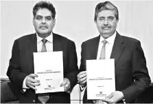  ??  ?? Sebi Chairman Ajay Tyagi (left), receives the report of the committee on corporate governance from Uday Kotak, who headed the panel, in Mumbai on Thursday