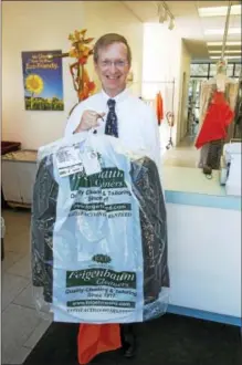  ?? PHOTO PROVIDED ?? Saratoga County Chamber of Commerce President Todd Shimkus picks up his dry cleaning on Wednesday at the new 18 Congress St. Feigenbaum Cleaners store in Saratoga Springs.
