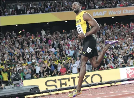  ?? KIRILL KUDRYAVTSE­V/AFP/GETTY IMAGES ?? Jamaica’s Usain Bolt cruised to a time of 10.07 seconds to easily win his heat of the men’s 100-metre race at the 2017 World Championsh­ips at London Stadium in England on Friday. The men’s 100-metre semifinals and finals take place Saturday.