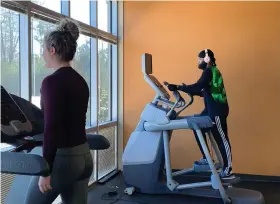  ?? (Special to The Commercial) ?? White Hall Wellness Center member Sydney Foster (left) works out on the treadmill while remaining socially distant from others. Member Kendrick Ventry (right) is on the Adaptive Motion Trainer.
