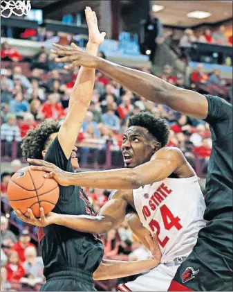  ?? [KYLE ROBERTSON/DISPATCH] ?? Andre Wesson splits Rutgers defenders Caleb Mcconnell, left, and Shaquille Doorson on a drive to the basket during a Feb. 2 game. Wesson is averaging 8.6 points per game and has 21 starts this season.