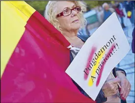  ??  ?? A woman holds a sign that translates to ‘Puigdemont to prison!’ in reference to Catalonia President Carlos Puigdemont and in support of Spain outside an auditorium during the Princess of Asturias awards ceremony in Oviedo on Friday.