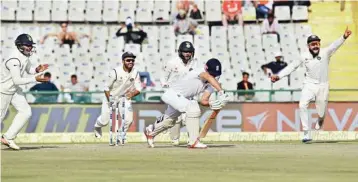  ?? PIC/PTI ?? England's captain Alastair Cook is bowled out by R Ashwin (not in picture) as Indian captain Virat Kohli and other players celebrate during the 3rd day of 3rd India-england Test in Mohali on Monday