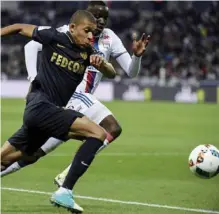  ??  ?? RHONE: Monaco’s French forward Kylian Mbappe Lottin (L) vies with Lyon’s defender Mouctar Diakhaby (R) during the French L1 football match between Olympique Lyonnais and AS Monaco. — AFP