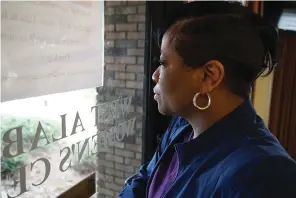  ?? The Associated Press ?? Alesia Horton, director of the West Alabama Women’s Center in Tuscaloosa, Ala., looks out the window at protesters on March 15. A deeply religious woman, she says of those who picket the clinic: “God isn’t theirs. God is all of ours.”