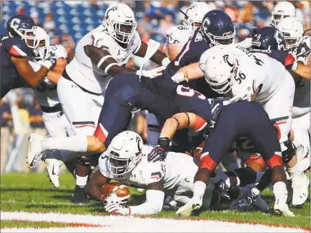  ?? Tim Bradbury / Getty Images ?? Cincinnati’s Michael Warren rushes for a touchdown in the second quarter against UConn on Saturday.