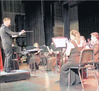  ?? /HIGH SCHOOL DISTRICT 218 ?? Justin Antos, who has been named a finalist for the 2020 GRAMMY Music Educator Award, directs a concert early this year at Eisenhower High School in Blue Island.