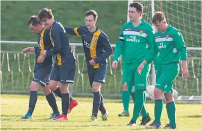  ??  ?? Neil Steward is congratula­ted after scoring Park Tool’s opening goal from the penalty spot against Hilltown Hotspurs.