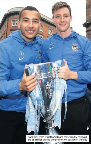  ??  ?? Dominic Hyam (right) and team-mate Rod McDonald are all smiles during the promotion parade in the city