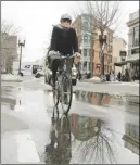  ?? AP PHOTO ?? Rev. Laura Everett rides her bike to a meeting of clergy in Cambridge, Mass.