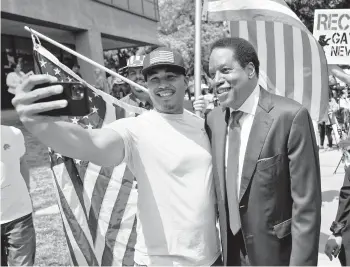  ?? MARCIO JOSE SANCHEZ/AP ?? Larry Elder, right, poses for selfies with supporters at a campaign stop July 13 in Norwalk, Calif.