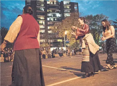  ?? J.P. MOCZULSKI PHOTOS FOR THE TORONTO STAR ?? The Tibetan Women's Associatio­n performs a Lhakar gathering in a public space at Parkdale Collegiate Institute. The new space, which includes community basketball courts, was part of an $800,000 improvemen­t project funded by the school board.