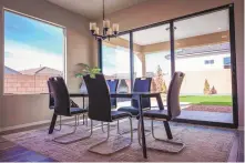  ?? ?? A dining area , left, and a bathroom of a Hakes Brothers model home in Los Diamantes.