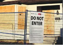  ?? GAVIN YOUNG ?? A home on Bedfield Court N.E. is boarded up on Monday morning after a cannabis grow-op was discovered on Friday.