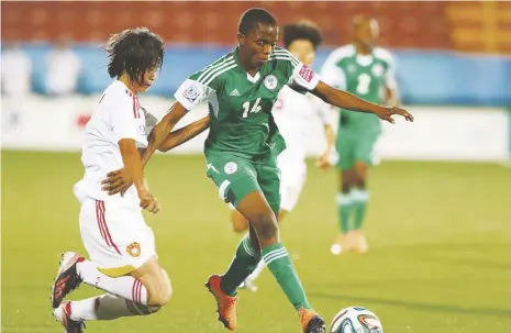  ??  ?? Jiameng Xu (L) and Rasheedat Ajibade vies for the ball during the match between Nigeria and China at the 2014 FIFA U17 Women World Cup in Costa Rica. She now plays for the Falconets.