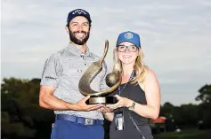  ??  ?? Adam Hadwin of Canada holds the trophy with fiancee Jessica Dawn after winning the Valspar Championsh­ip during the final round at Innisbrook Resort Copperhead Course on March 12, 2017 in Palm Harbor, Florida. Hadwin won with a score of -14. - AFP photo