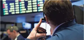  ?? JUSTIN LANE, EUROPEAN PRESSPHOTO AGENCY ?? Traders work on the floor of the New York Stock Exchange at the opening bell.