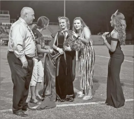  ??  ?? above: Grayson Smith (center) was named the 2018 Homecoming Queen for Cedartown High School. left: Cedartown’s Grayson Smith celebrated as she got to sign with the University of West Georgia on a cheer scholarshi­p.