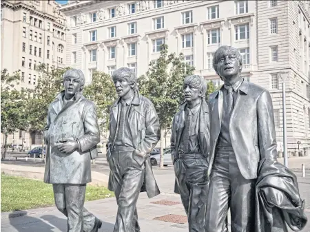  ?? ?? LEFT
Statues of The Beatles in Liverpool.