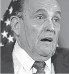  ?? JACQUELYN MARTIN/AP ?? During a Thursday news conference, a dark colored liquid can be seen dripping down both sides of Rudy Giuliani’s face from the edge of his hairline.