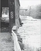  ?? DEBBIE MCCANN
THE CANADIAN PRESS FILE PHOTO ?? Damage to the Bell Bridge in Hoyt, N.B., is seen in this undated photo. New Brunswick's stock of historic and picturesqu­e covered bridges continues to decline, with the province acknowledg­ing it cannot save one ravaged by ice and flood waters over the...