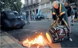  ?? | MATILDE CAMPODONIC­O/AP ?? Uruguayan painter Carlos Paez Vilaro fire-tunes his drum Feb. 14 before taking part in Las Llamadas or Calls parade during Carnival celebratio­ns in Montevideo, Uruguay.