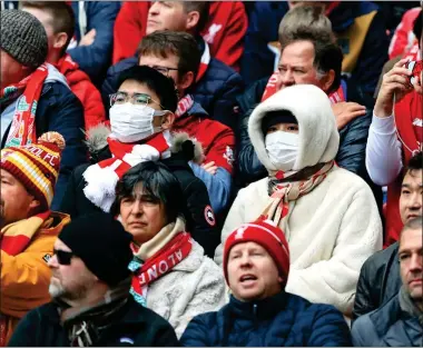  ??  ?? DEFENCES: Liverpool football fans wore face masks at Anfield yesterday. Left: Hand sanitisers at yesterday’s Twickenham rugby internatio­nal