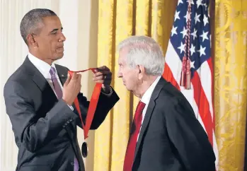  ?? ALEX WONG/GETTY ?? President Barack Obama presents the National Humanities Medal to Larry McMurtry at the White House in 2015. McMurtry was honored for his books, essays and screenplay­s.