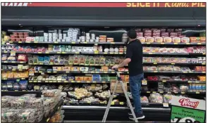  ?? (AP) ?? An employee stocks shelves at a Grocery Outlet store in Pleasanton, Calif. in September. Thursday’s U.S. consumer price index report for September will likely spark a stock selloff if inflation clocks in above the year-over-year August reading of 8.3%, the JPMorgan Chase & Co.’s trading desk said.