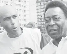  ??  ?? Picture taken on April 12, 2007 of Brazilian football star Pele (right) and his son, former footballer and coach of goalkeeper­s in Santos FC, Edson Cholbi Nascimento, aka Edinho, in Santos. — AFP photo