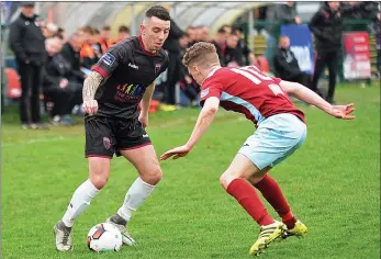  ??  ?? Wexford right back Ricky Fox takes on Ian Mylod of Cobh Ramblers (Photograph­s: George Hatchell).