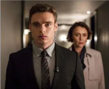  ?? SOPHIE MUTEVELIAN — NETFLIX VIA AP ?? This image released by Netflix shows Richard Madden, left, and Keeley Hawes in a scene from “Bodyguard.” On Tuesday the program was nominated for an Emmy Award for outstandin­g drama series.