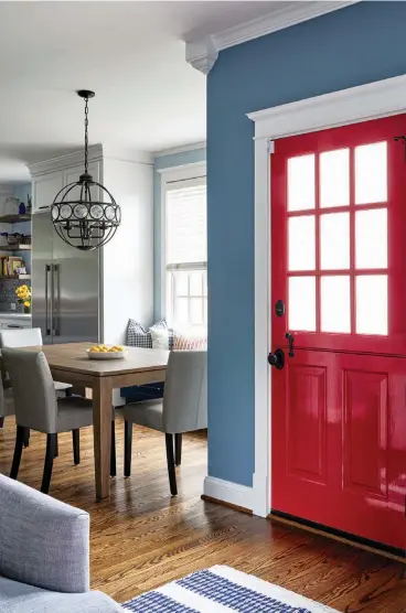  ??  ?? Details and finishing touches complete the look and give the designers a chance to express the unique qualities of the design. Here, the bright red of the Dutch door leading to the backyard was a custom feature and mirrors the
showstoppi­ng Bertazzoni range across the room.