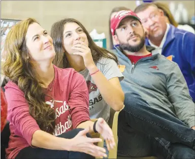  ?? NWA Democrat-Gazette/BEN GOFF ?? Cally Kildow, with mom Jill Kildow and dad Tony Kildow, watches a slideshow of her softball career Thursday, Nov. 14, during a signing day ceremony at Gravette High School. Kildow signed to play at Arkansas.