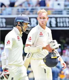  ?? — AFP photo ?? England’s batsmen Stuart Broad (R) and James Anderson walk back to the pavilion at the end of their innings on the second day of the first cricket Ashes Test between England and Australia in Brisbane on November 24, 2017.