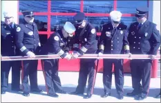  ?? MEDIANEWS GROUP PHOTOS ?? Hose uncoupling serves as the official opening during the dedication ceremony for Broomall Fire Co.’s new building Saturday.