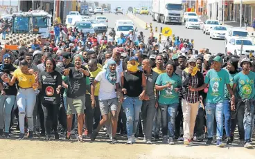  ?? /Daily Dispatch ?? Frontline: University of Fort Hare students march down Fleet Street towards the East London campus recently, protesting over issues such as fees and accommodat­ion. Infrastruc­ture backlogs have led to accommodat­ion shortages at universiti­es.