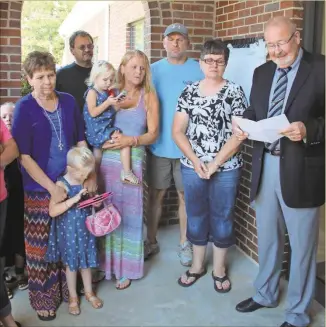  ??  ?? Rev. Calvin Brown (right) and family members of Mayor Brenda Gazaway unveiled a plaque put in place in her honor (see right) on Sept. 4, 2016.