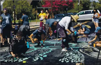  ?? PHOTOS BY ANDA CHU — STAFF PHOTOGRAPH­ER ?? Activists, artists and local residents paint a street mural near the Gardner Community Center in San Jose on Saturday. Organizers drew inspiratio­n from a Black Lives Matter mural painted in San Jose early this month.