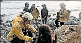  ?? MONTEREY COUNTY SHERIFF’S OFFICE/AP ?? Rescuers tend to Angela Hernandez, foreground center, in Morro Bay, Calif., on Friday.