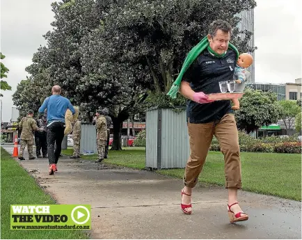  ?? PHOTO: WARWICK SMITH/FAIRFAX NZ ?? Palmerston North mayor Grant Smith keeps his poise during the high heel dash through The Square.