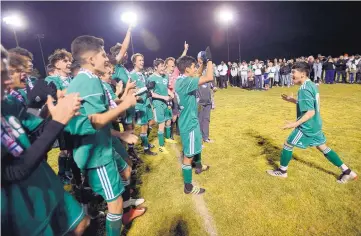  ?? ADOLPHE PIERRE-LOUIS/JOURNAL ?? Albuquerqu­e High’s Christian Nava, right, celebrates with his teammates after the Bulldogs beat Hobbs Friday to win the boys Class 5A state championsh­ip.