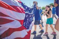  ?? ROBERTO E. ROSALES/JOURNAL ?? Anabell Saenz, 6, right, of Las Cruces, protests with her family outside Border Patrol Headquarte­rs on Tuesday. The protesters voiced opposition to minors being separated from their parents.