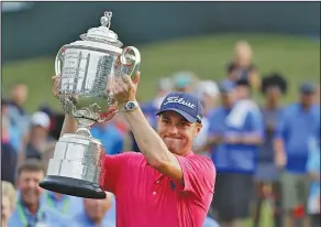  ?? Associated Press ?? Big winner: Justin Thomas poses with the Wanamaker Trophy after winning the PGA Championsh­ip golf tournament at the Quail Hollow Club Sunday in Charlotte, N.C.