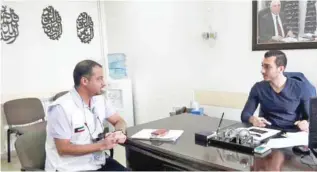  ??  ?? KRCS delegate Dr Musa’ad Al-Enezi speaks with Rayak Hospital’s director Dr Hamad Al-Mohammad.