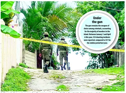  ?? FILE ?? Soldiers make their way to an area where five persons were shot, two fatally, in Rose Heights, St James, last month.