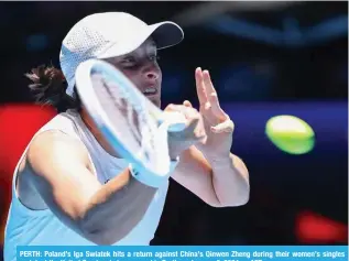  ?? AFP ?? PERTH: Poland’s Iga Swiatek hits a return against China’s Qinwen Zheng during their women’s singles match at the United Cup tennis tournament in Perth on January 3, 2024.—